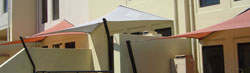 Shade sails use track and bent posts on balcony