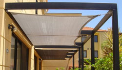 Pergola covered with shade sail using track