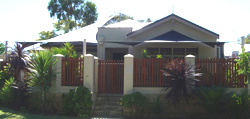 Shade sail attached to house using stainless steel wall mounts