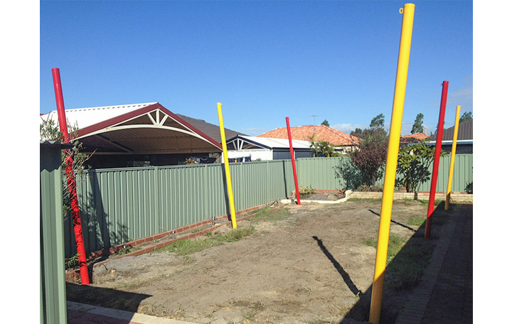 Photograph of Round galvanised steel shade sail posts that have been powder coated.  Posts are fixed into the ground with concrete to a minimum of 1 metre depth.