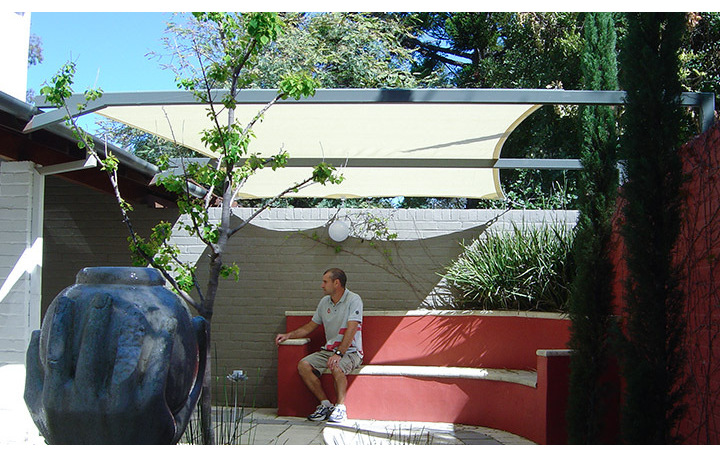 Photograph of Flat sail on top of pergola structure. Fabric is Comshade porcelain.