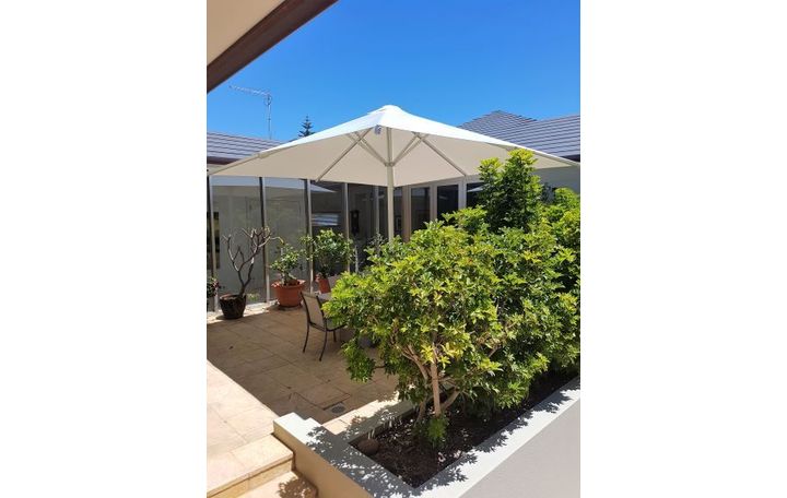 Photograph of Here is a photograph of a 4.5m square centre post umbrella, with a white PVC canopy