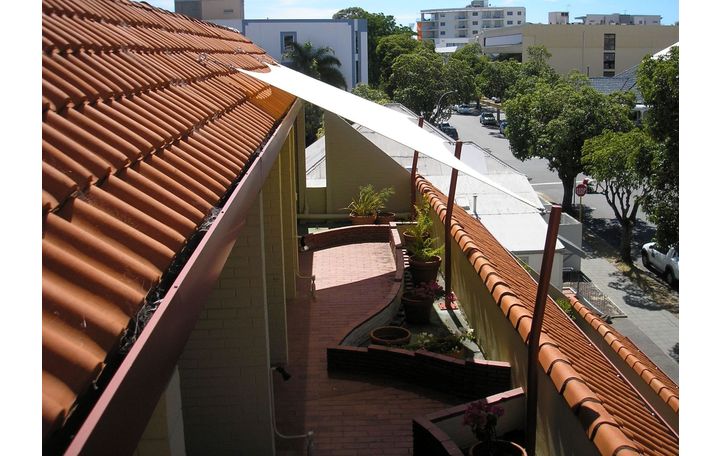 Photograph of Comshade Material in a Porcelain colour.
Roof Mounts and poles used.