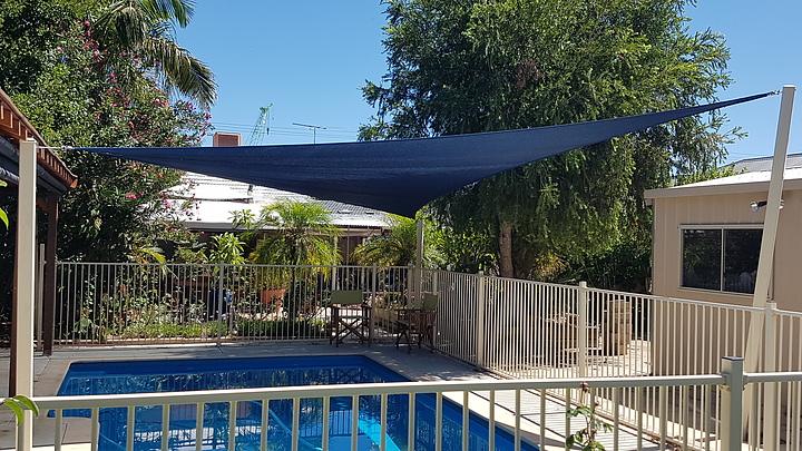 Photograph of Sail over part of a pool
Sail suspended on 4 posts to form the hypar sail
Extreme32 Navy Blue fabric

