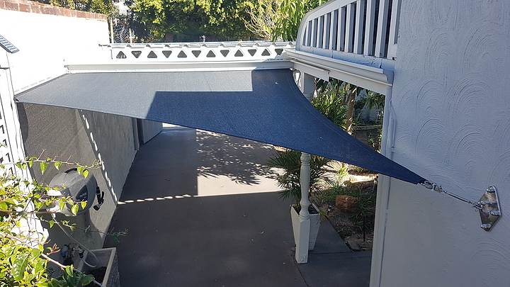 Photograph of The  small sail is mounted flush (tracking system) to the eastern edge of a carport and adjoining wall. This resulted in a greater amount of shade to protect vehicle parked under the carport.
Rainbow Z16  Charcoal
